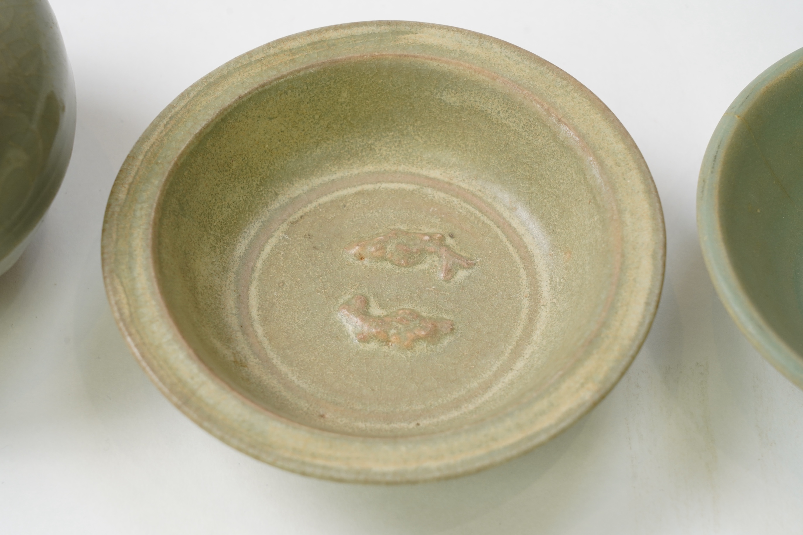 A group of four Chinese Celadon wares - two vases and two dishes, tallest vase 16cm.